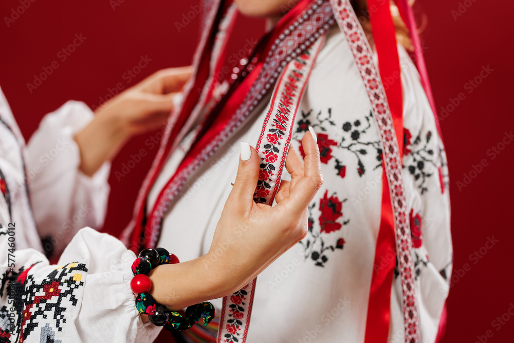 Ukrainian women in traditional ethnic clothing and floral red wreath on viva magenta studio background. National embroidered dress call vyshyvanka. Pray for Ukraine