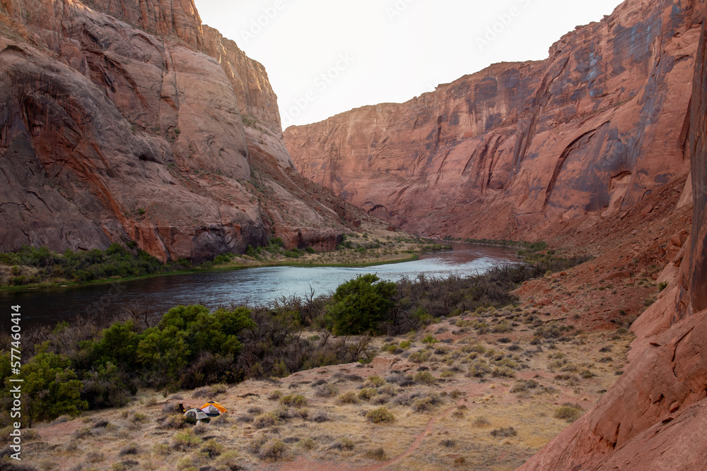 Tents near Colorado river in Glen Canyon, view from above, sunset