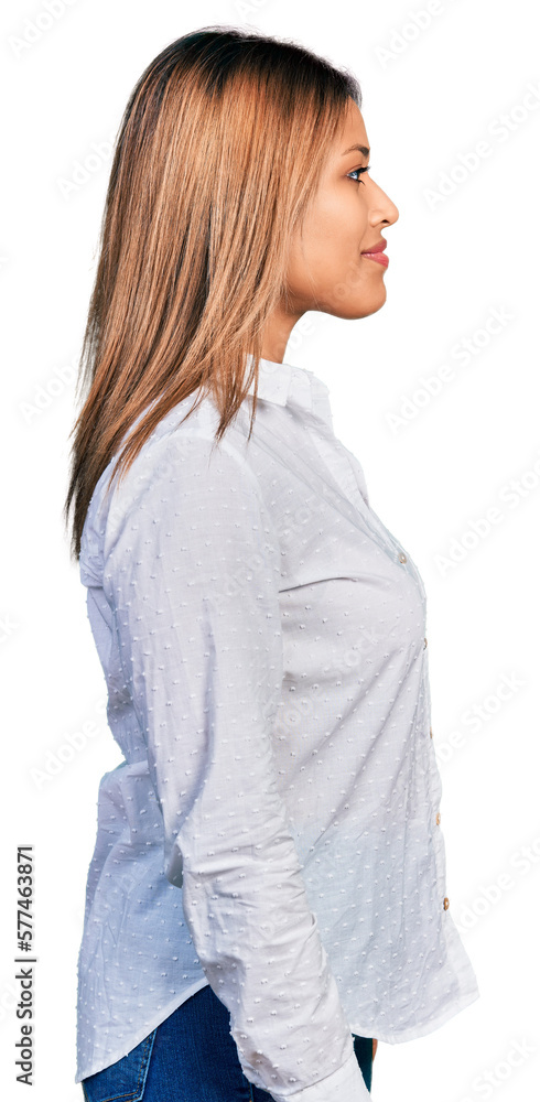 Young hispanic woman wearing casual white shirt looking to side, relax profile pose with natural face with confident smile. Young hispanic woman wearing casual white shirt looking to side, relax profile pose with natural face with confident smile.