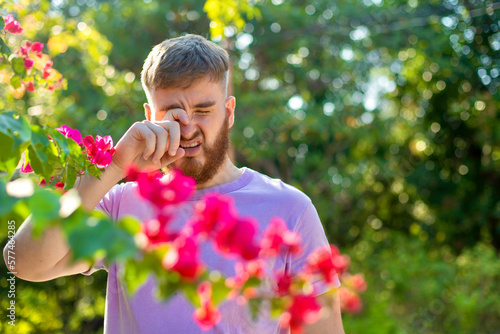 Fotografie Portrait of handsome young allergic man is suffering from pollen allergy or cold