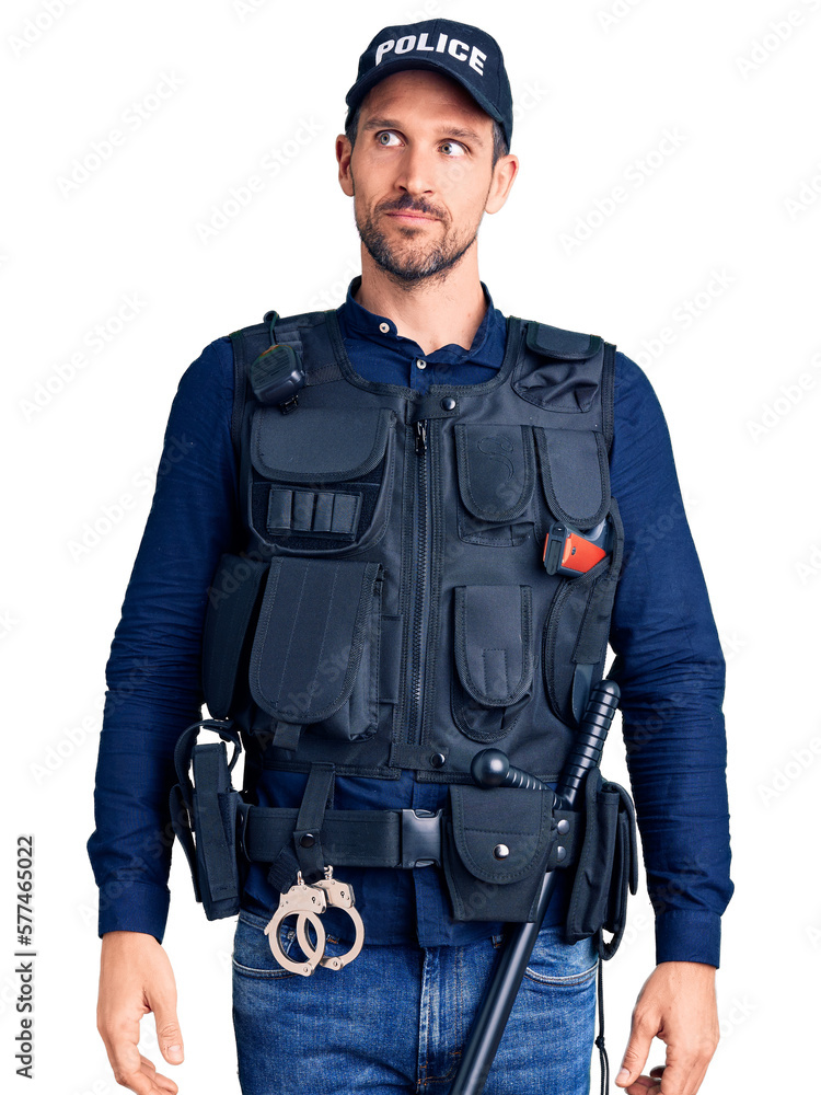 Young handsome man wearing police uniform smiling looking to the side and staring away thinking. Young handsome man wearing police uniform smiling looking to the side and staring away thinking.