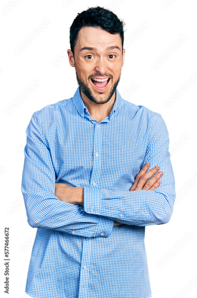 Hispanic man with beard with arms crossed gesture celebrating crazy and amazed for success with open eyes screaming excited. Hispanic man with beard with arms crossed gesture celebrating crazy and amazed for success with open eyes screaming excited.