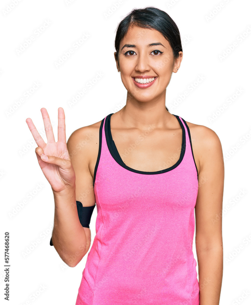 Beautiful asian young sport woman wearing sportswear and arm band showing and pointing up with fingers number three while smiling confident and happy. Beautiful asian young sport woman wearing sportswear and arm band showing and pointing up with fingers number three while smiling confident and happy.