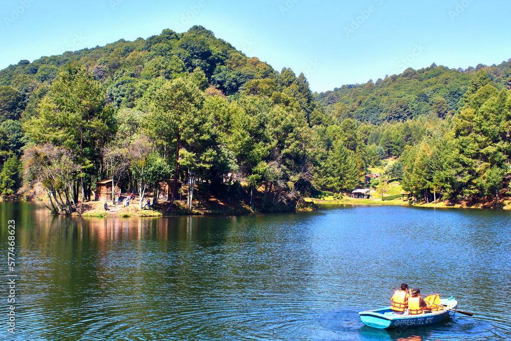 lake in forest at sunny day, boat on the water with people, dam of the llano, villa del carbon state of mexico 