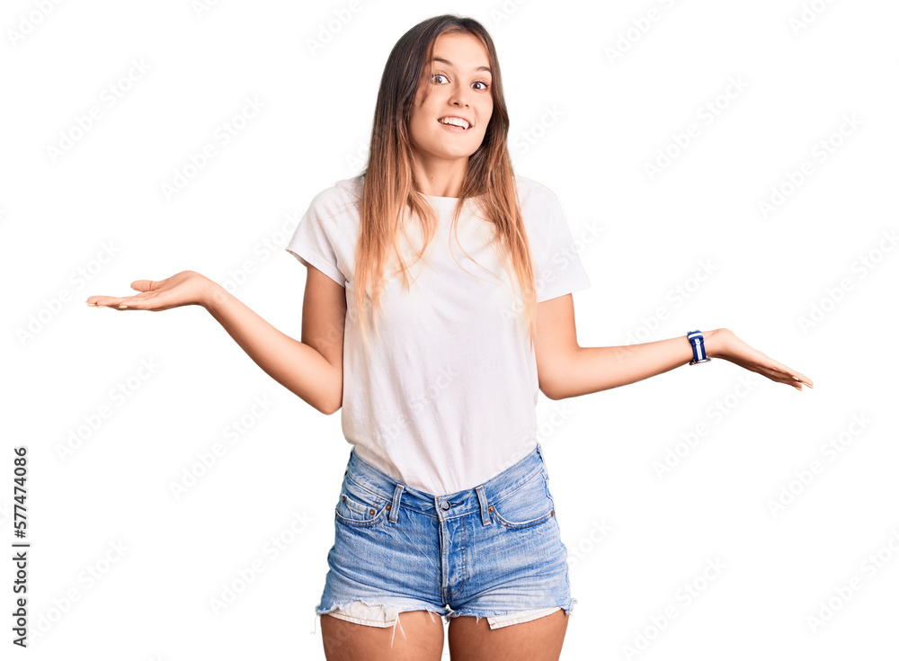 Beautiful caucasian woman wearing casual white tshirt smiling showing both hands open palms, presenting and advertising comparison and balance Beautiful caucasian woman wearing casual white tshirt smiling showing both hands open palms, presenting and advertising comparison and balance