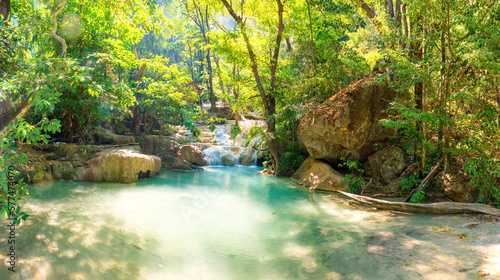 Waterfall in tropical landscape  green trees in wild jungle forest