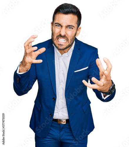 Fotografía Young hispanic man wearing business jacket shouting frustrated with rage, hands