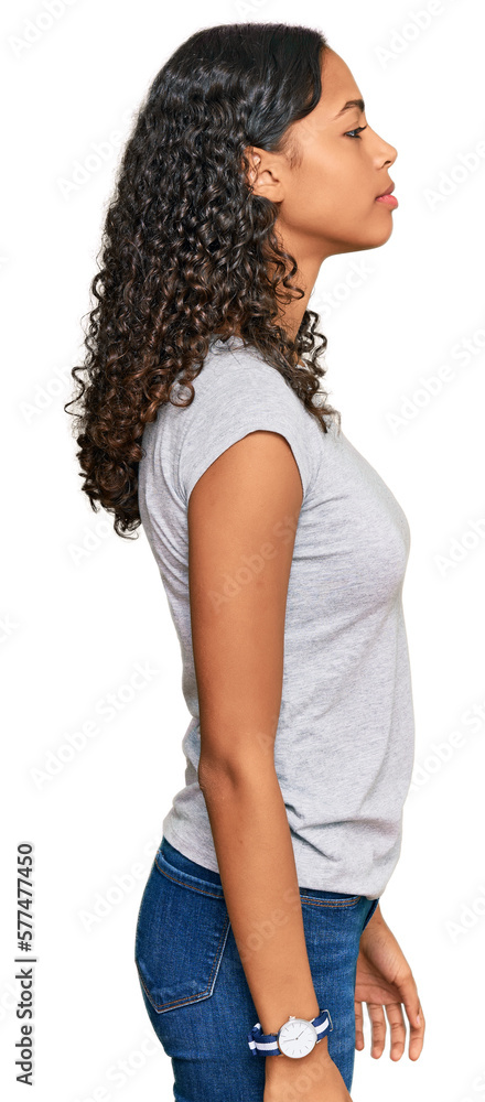 Young african american girl wearing casual clothes looking to side, relax profile pose with natural face and confident smile. Young african american girl wearing casual clothes looking to side, relax profile pose with natural face and confident smile.