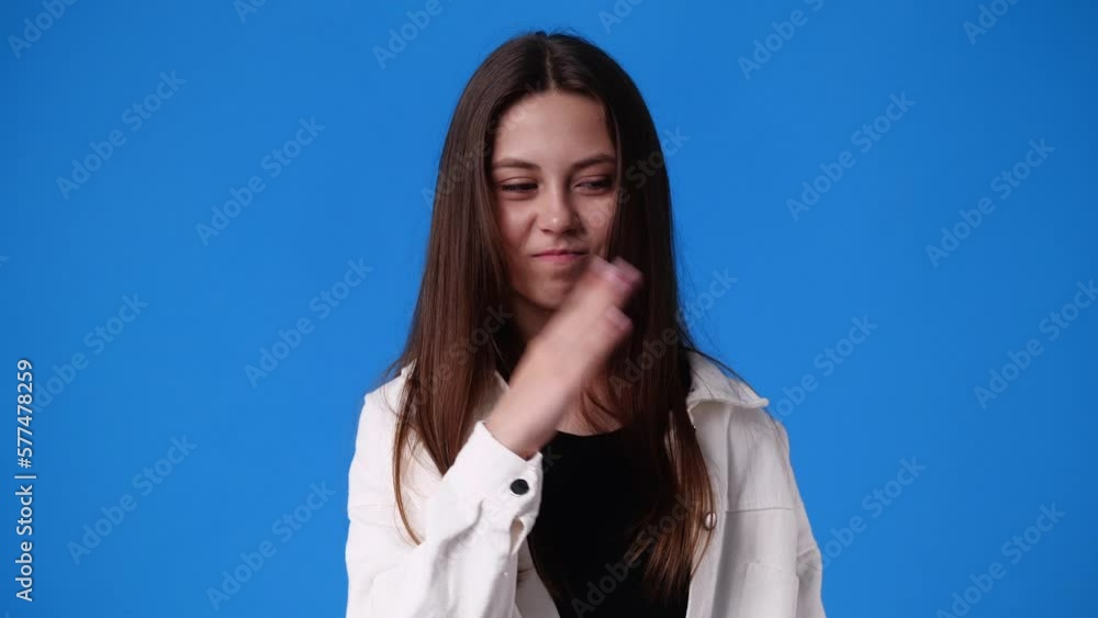 4k video of one girl closes the nose against the smell over blue background. 4k video of one girl closes the nose against the smell over blue background.
