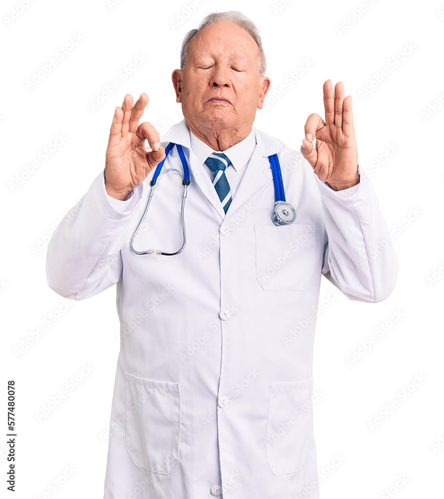 Senior handsome grey-haired man wearing doctor coat and stethoscope relaxed and smiling with eyes closed doing meditation gesture with fingers. yoga concept. Senior handsome grey-haired man wearing doctor coat and stethoscope relaxed and smiling with eyes closed doing meditation gesture with fingers. yoga concept.