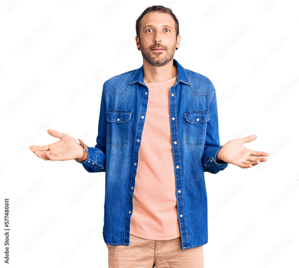 Young handsome man wearing casual clothes clueless and confused expression with arms and hands raised. doubt concept. Young handsome man wearing casual clothes clueless and confused expression with arms and hands raised. doubt concept.