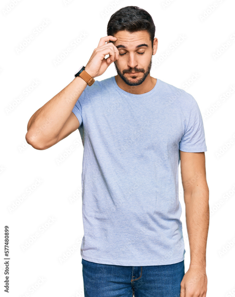 Young hispanic man wearing casual clothes worried and stressed about a problem with hand on forehead, nervous and anxious for crisis Young hispanic man wearing casual clothes worried and stressed about a problem with hand on forehead, nervous and anxious for crisis
