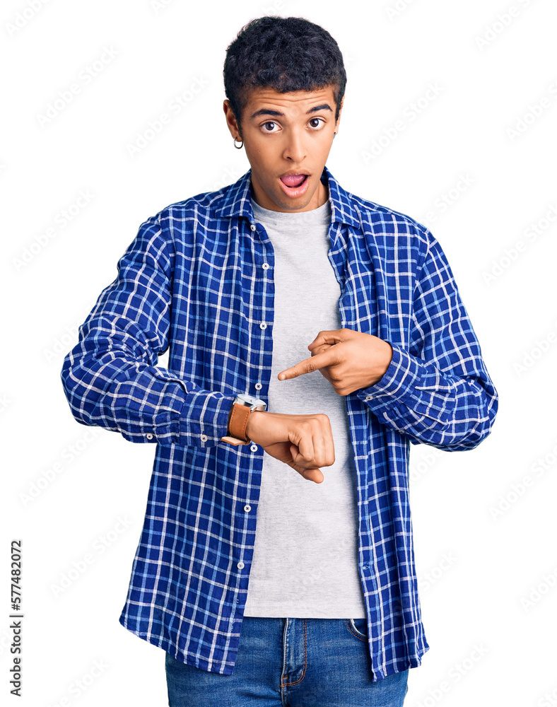 Young african amercian man wearing casual clothes in hurry pointing to watch time, impatience, upset and angry for deadline delay Young african amercian man wearing casual clothes in hurry pointing to watch time, impatience, upset and angry for deadline delay