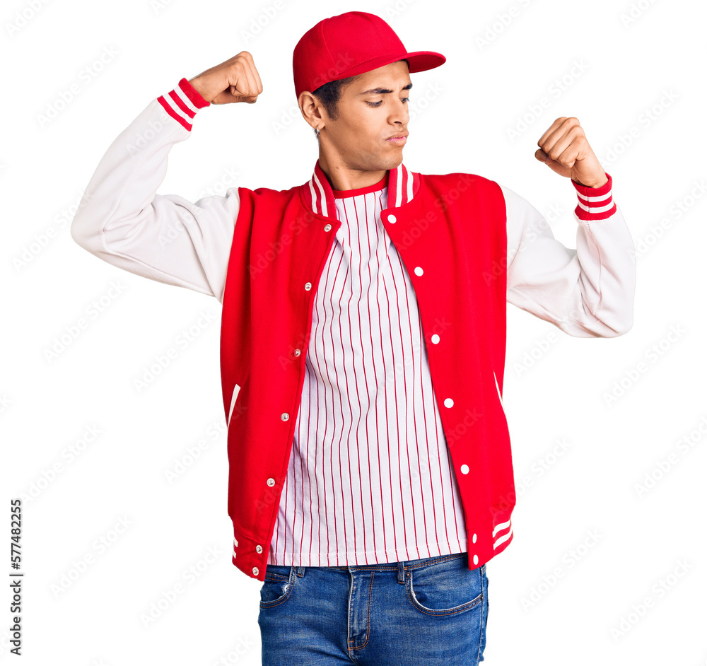 Young african amercian man wearing baseball uniform showing arms muscles smiling proud. fitness concept. Young african amercian man wearing baseball uniform showing arms muscles smiling proud. fitness concept.