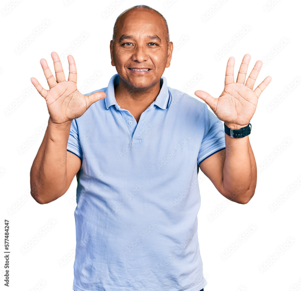 Hispanic middle age man wearing casual t shirt showing and pointing up with fingers number ten while smiling confident and happy. Hispanic middle age man wearing casual t shirt showing and pointing up with fingers number ten while smiling confident and happy.