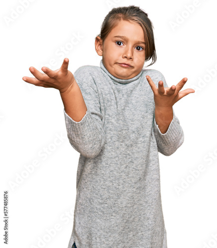 Принти на полотні Little beautiful girl wearing casual turtleneck sweater clueless and confused expression with arms and hands raised