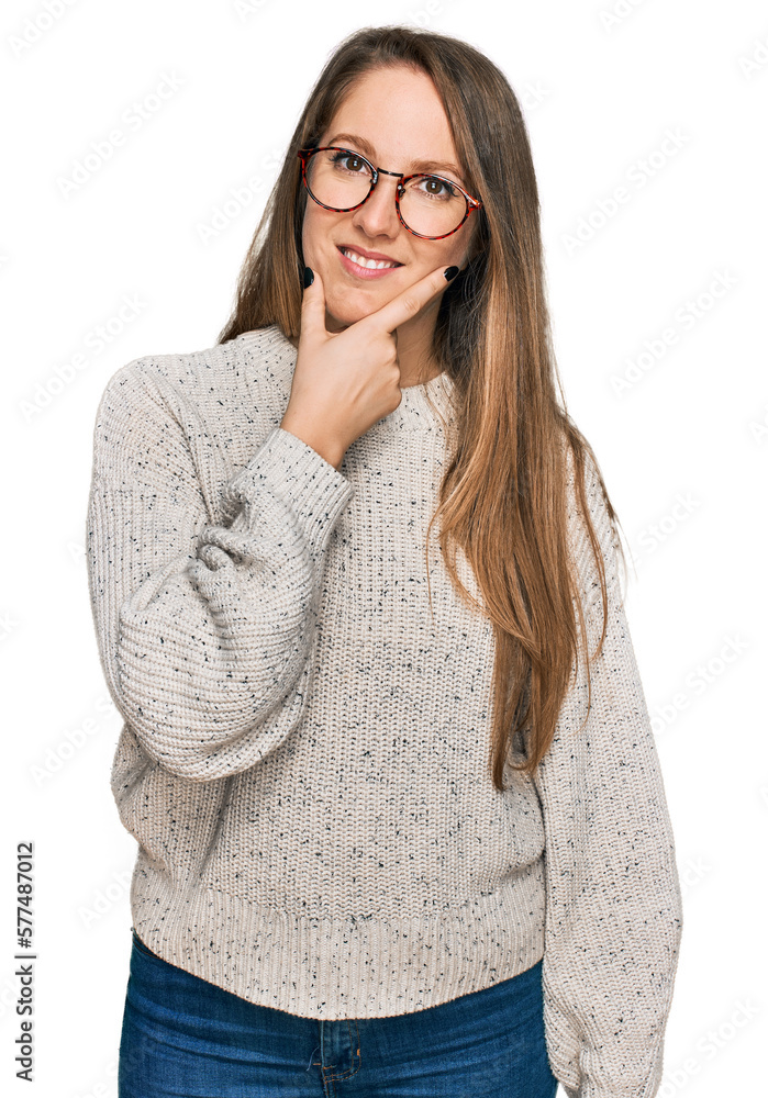 Young blonde woman wearing casual sweater and glasses looking confident at the camera smiling with crossed arms and hand raised on chin. thinking positive. Young blonde woman wearing casual sweater and glasses looking confident at the camera smiling with crossed arms and hand raised on chin. thinking positive.