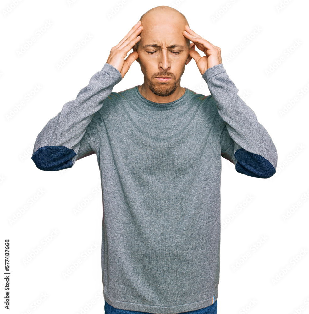 Naklejka premium Bald man with beard wearing casual clothes with hand on head for pain in head because stress. suffering migraine.