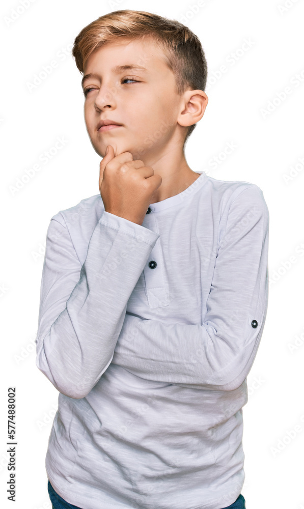 Little caucasian boy kid wearing casual clothes with hand on chin thinking about question, pensive expression. smiling with thoughtful face. doubt concept. Little caucasian boy kid wearing casual clothes with hand on chin thinking about question, pensive expression. smiling with thoughtful face. doubt concept.