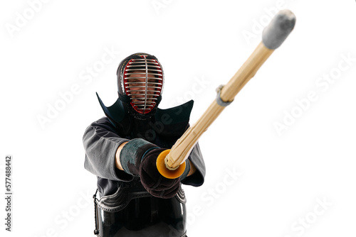 Fighter. Portrait of man, professional kendo athlete in uniform posing with shinai sword against white studio background. Concept of martial arts, sport, Japanese culture, action and motion