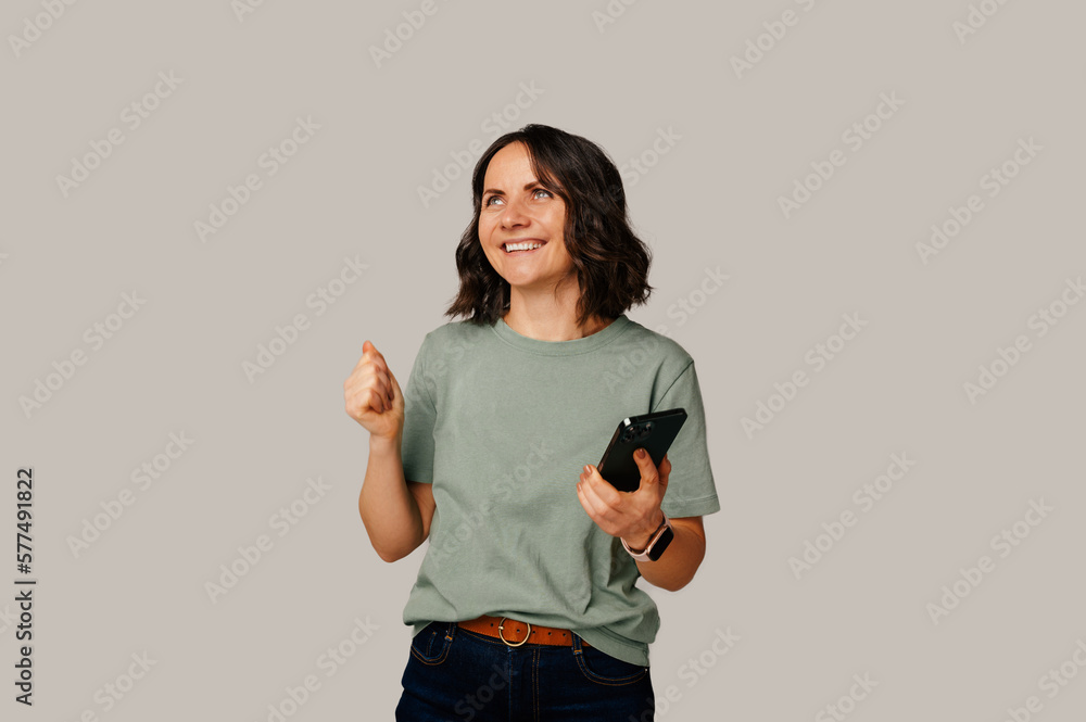 I got some exciting new over my phone says a woman holding her cellphone. I got some exciting new over my phone says a woman holding her cellphone.