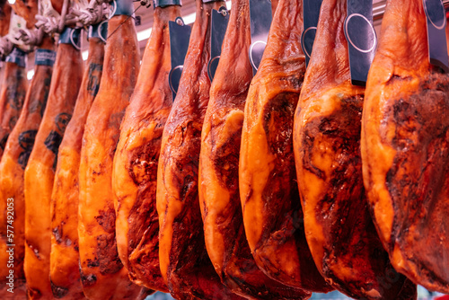 Traditional hanging smoked whole ham leg at the street market in Catalonia.