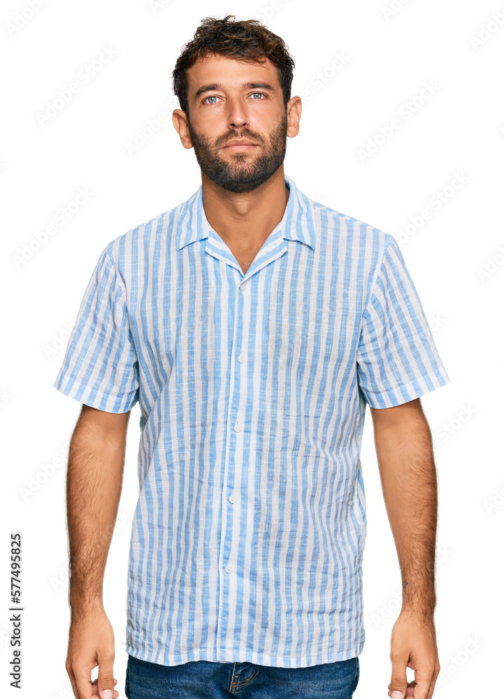 Handsome young man with beard wearing casual fresh shirt relaxed with serious expression on face. simple and natural looking at the camera. Handsome young man with beard wearing casual fresh shirt relaxed with serious expression on face. simple and natural looking at the camera.