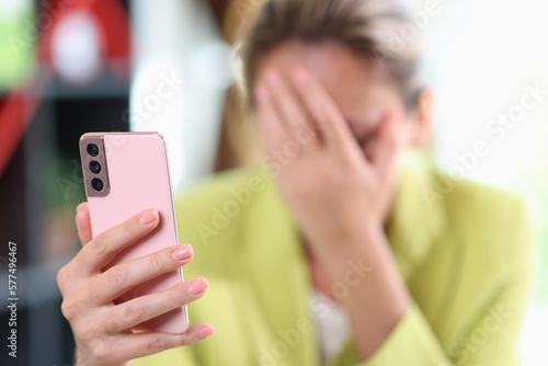 Female hand holding modern smartphone in hand