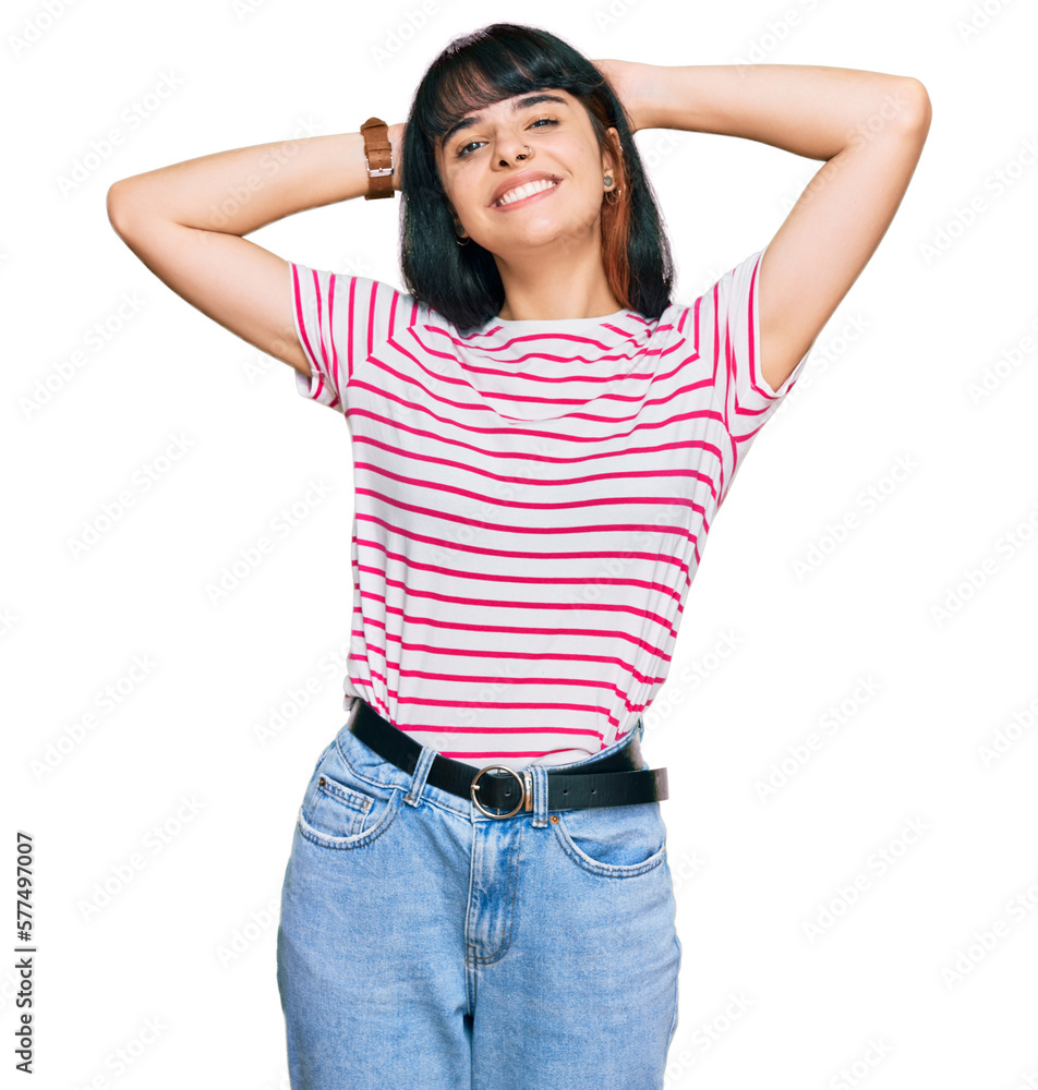 Young hispanic girl wearing casual clothes relaxing and stretching, arms and hands behind head and neck smiling happy Young hispanic girl wearing casual clothes relaxing and stretching, arms and hands behind head and neck smiling happy