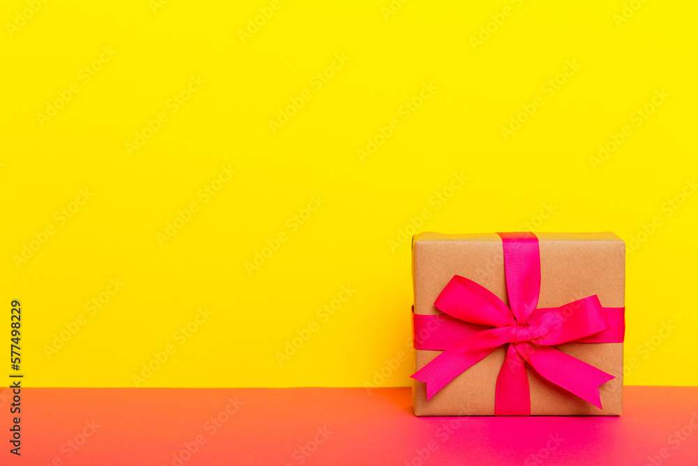 holiday paper present tied pink ribbon bow top view with copy space. Flat lay holiday background. Birthday or christmas present. Christmas gift box concept with copy space holiday paper present tied pink ribbon bow top view with copy space. Flat lay holiday background. Birthday or christmas present. Christmas gift box concept with copy space