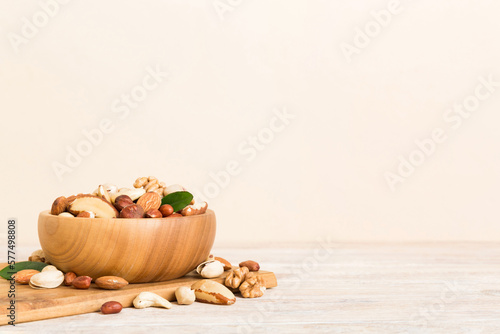 mixed nuts in bowl. Mix of various nuts on colored background. pistachios, cashews, walnuts, hazelnuts, peanuts and brazil nuts