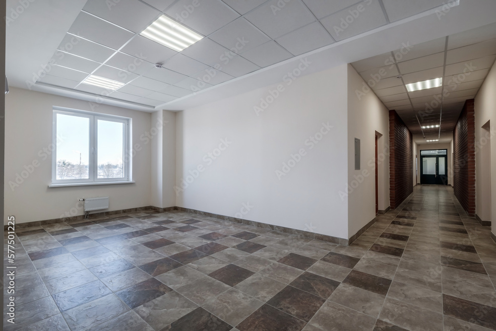 empty long corridor with red brick walls in interior of modern apartments, office or clinic. empty long corridor with red brick walls in interior of modern apartments, office or clinic.