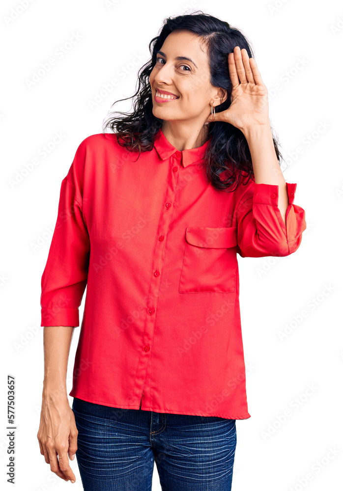 Young beautiful hispanic woman wearing casual clothes smiling with hand over ear listening an hearing to rumor or gossip. deafness concept. Young beautiful hispanic woman wearing casual clothes smiling with hand over ear listening an hearing to rumor or gossip. deafness concept.