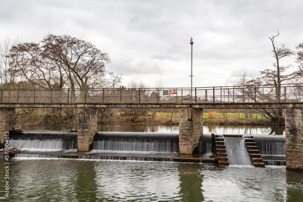The river Tone flowing through French weir in Taunton in Somerset