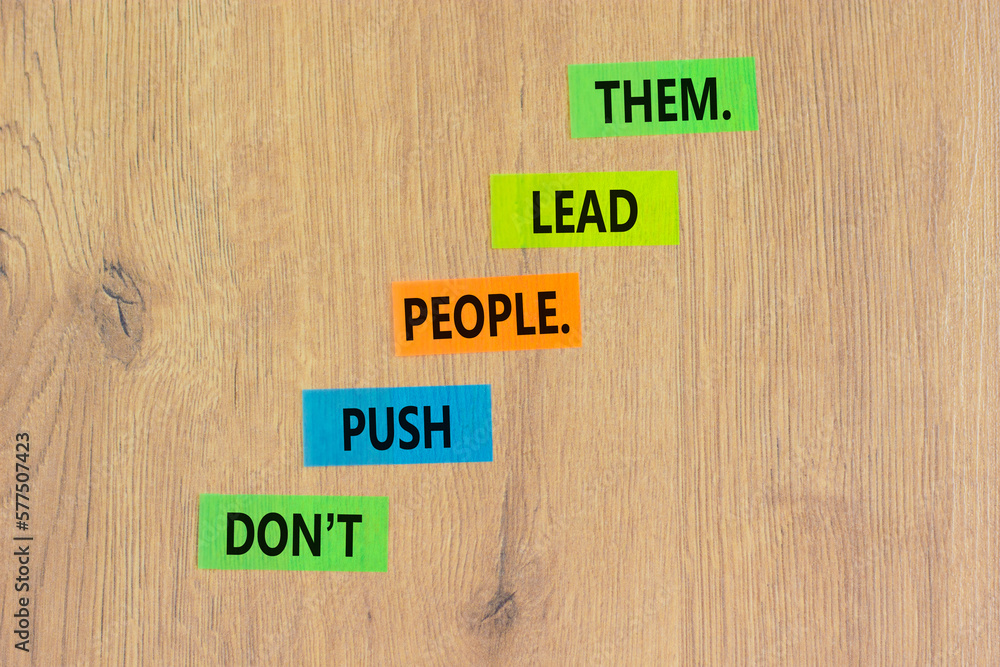 Push or lead people symbol. Concept words Do not push people lead them on colored paper. Beautiful wooden table wooden background. Business Push or lead people concept. Copy space. Push or lead people symbol. Concept words Do not push people lead them on colored paper. Beautiful wooden table wooden background. Business Push or lead people concept. Copy space.