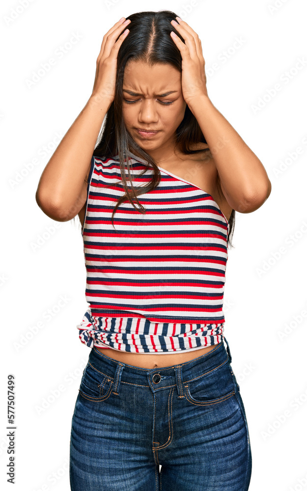 Beautiful hispanic woman wearing casual clothes suffering from headache desperate and stressed because pain and migraine. hands on head. Beautiful hispanic woman wearing casual clothes suffering from headache desperate and stressed because pain and migraine. hands on head.