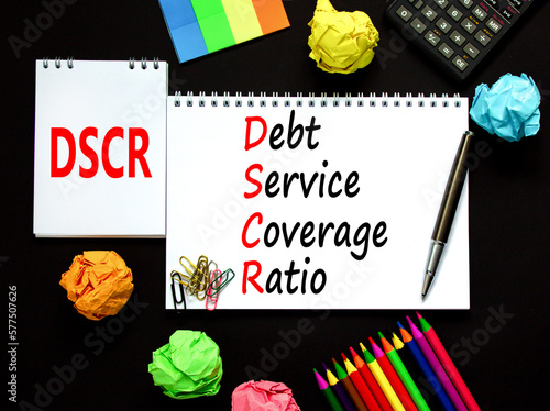 DSCR debt service coverage ratio symbol. Concept words DSCR debt service coverage ratio on white note on beautiful black background. Business DSCR debt service coverage ratio concept. Copy space. photo