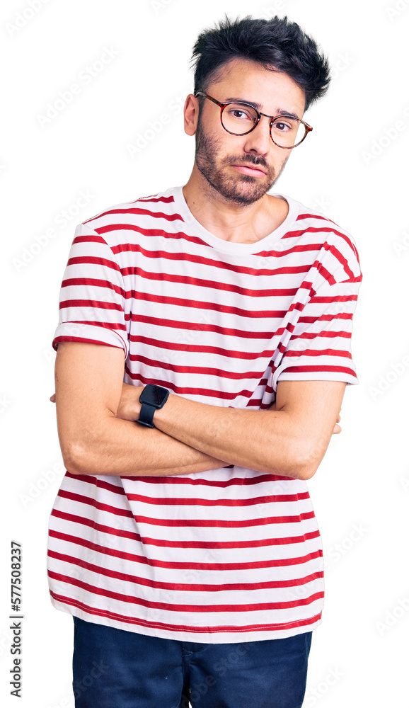 Young hispanic man wearing casual clothes shaking and freezing for winter cold with sad and shock expression on face Young hispanic man wearing casual clothes shaking and freezing for winter cold with sad and shock expression on face