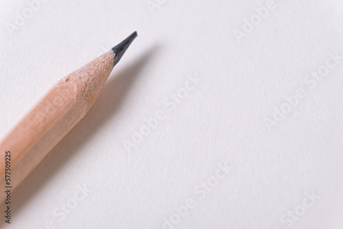 Notepad and wooden pencil. Minimalistic template with copy space, close up of wooden pencil on blank notebook paper