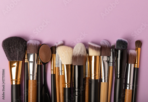 Set of cosmetic brushes on a lilac background. Makeup brushes. Makeup tool. Beauty concept.Professional brushes for applying cosmetics eyeshadows, make-up powder. Place for text. Copy space. Flat lay.