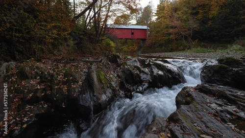 A covered bridge and a creek during fall in New England