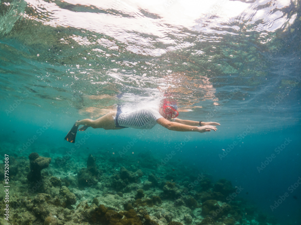 woman snorkeling in clear tropical sea woman snorkeling in clear tropical sea