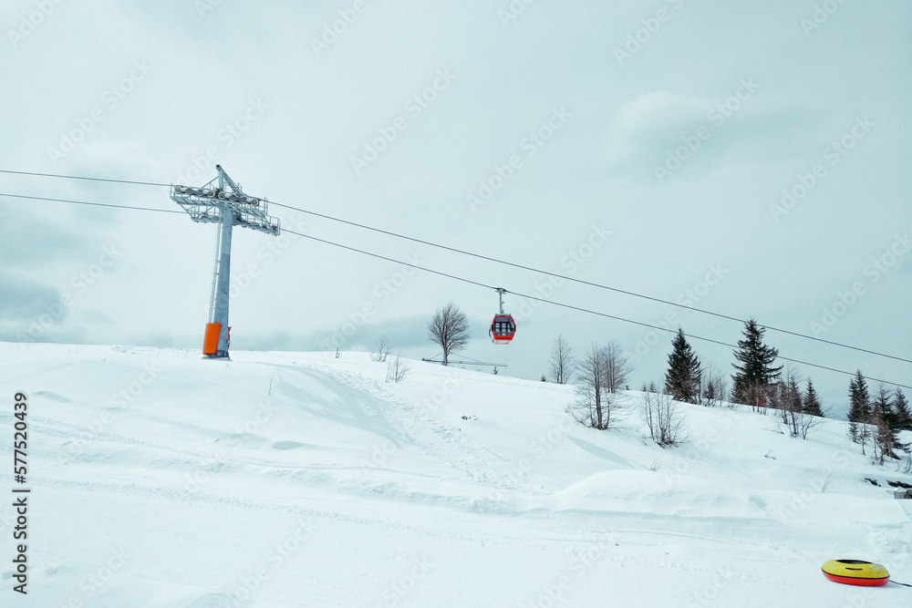 ski resort Goderdzi, Georgia. mountains are covered with snow. Red cable car above and mountains behind - Image ski resort Goderdzi, Georgia. mountains are covered with snow. Red cable car above and mountains behind - Image