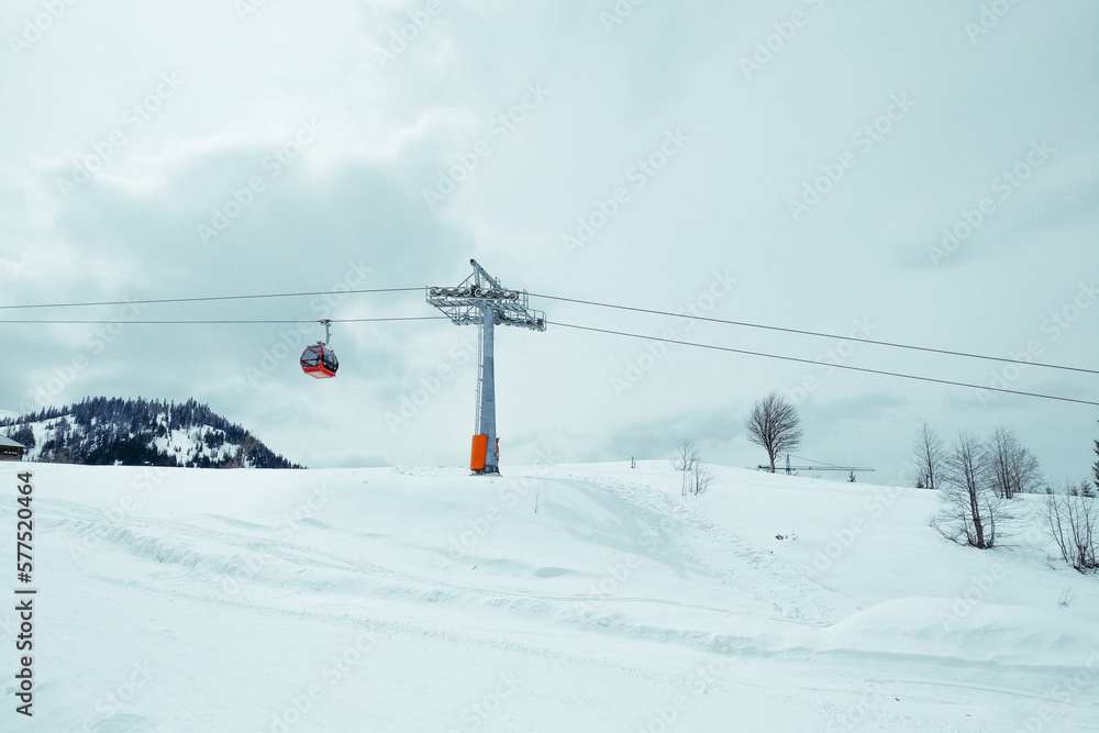 ski resort Goderdzi, Georgia. mountains are covered with snow. Red cable car above and mountains behind  - Image