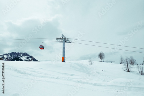 ski resort Goderdzi, Georgia. mountains are covered with snow. Red cable car above and mountains behind  - Image © ni