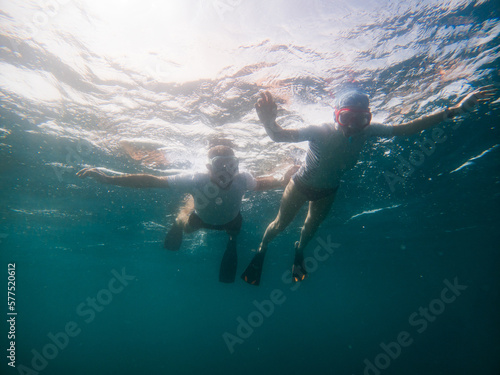 couple snorkeling in clear tropical sea