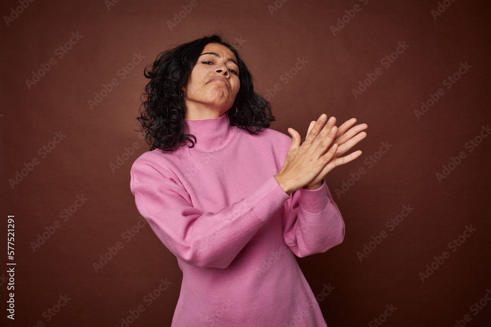Young colombian curly hair woman isolated on brown background feeling energetic and comfortable, rubbing hands confident. Young colombian curly hair woman isolated on brown background feeling energetic and comfortable, rubbing hands confident.