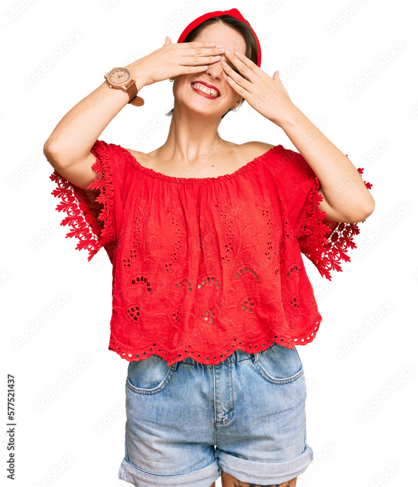 Young brunette woman with short hair wearing casual summer clothes and diadem covering eyes with hands smiling cheerful and funny. blind concept. Young brunette woman with short hair wearing casual summer clothes and diadem covering eyes with hands smiling cheerful and funny. blind concept.