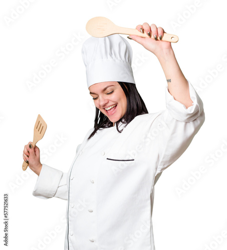 Young cook woman holding wooden spoon and fork isolated