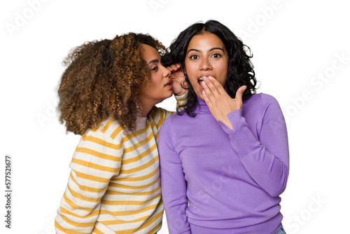 Canvastavla Two female friends isolated in studio is saying a secret hot braking news and lo